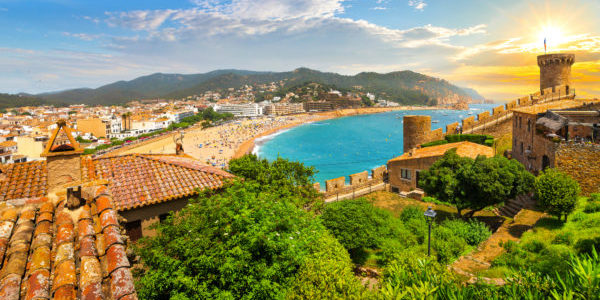 View from the 12th century medieval castle along the Costa Brava coast of the Mediterranean sea, sandy beach, turquoise waters and whitewashed town of Tossa de Mar, Spain.
